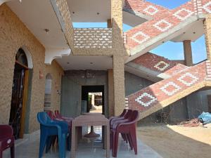 a table and chairs sitting on a patio at Manzil Al-Wahati in Bawati