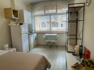 a bedroom with a bed and a kitchen with a window at Ashur mondello in Palermo