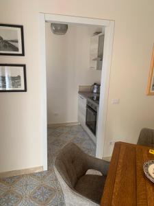 a living room with a table and a kitchen at La Casa di Loris in Lerici
