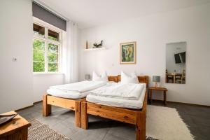 a bedroom with a large bed with white sheets at Hotel Bolter Mühle - DZ Gerstenkammer in Rechlin