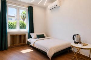 a small bedroom with a bed and a window at Villa In Bed in Naples +14 photos