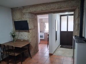 a kitchen and dining room with a table and a stove at Casa YaraMaya in Carballino