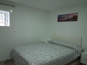 a bed in a bedroom with a picture on the wall at Casa YaraMaya in Carballino +8 photos