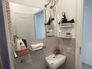 a bathroom with a sink and a mirror at Ashur mondello in Palermo +10 photos