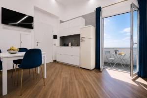 a kitchen and dining room with a view of the ocean at Villa In Bed in Naples