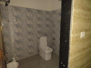 a bathroom with a toilet and a wall covered in fishes at Hotel Murlidhar in Chikāra