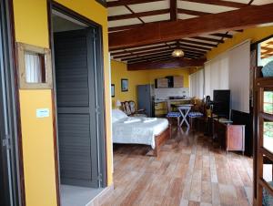a bedroom with a bed and a desk in a room at Mirador Finca Morrogacho in Manizales