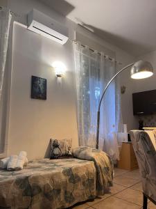 a bedroom with a bed and a lamp in it at Alice's House in Civitavecchia