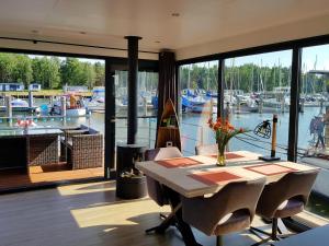 a dining room with a table and a view of a marina at Floating Comfort in Peenemünde in Peenemünde