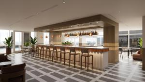 a restaurant with a bar with chairs and tables at JW Marriott Atlanta Downtown in Atlanta