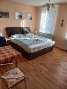 a bedroom with a bed and a wooden floor at Ferienwohnung Familie Rudolf in Coswig
