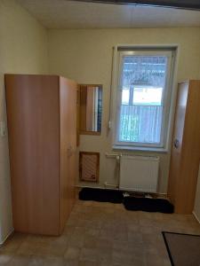an empty room with a window and a radiator at Ferienwohnung Familie Rudolf in Coswig +28 photos