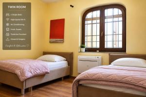 two beds in a room with a menu on the wall at Villa Pool & Sun Durrës in Durrës +29 photos