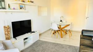 a living room with a television and a table at Vieira's House in Barreiro +22 photos