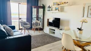 a living room with a couch and a table and a television at Vieira's House in Barreiro