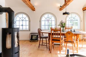 a kitchen and dining room with a wood stove at Min Hus Anno 1875 in Bönstrup