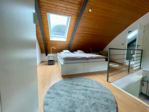 a bedroom with a bed and a wooden ceiling at Urlaubsschmiede Mosel in Traben-Trarbach