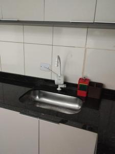 a bathroom sink with a faucet on a wall at Casa J&G in Fazenda Rio Grande