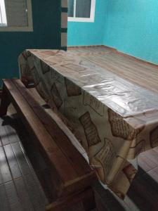 a wooden table with a bench in a room at Casa J&G in Fazenda Rio Grande +6 photos