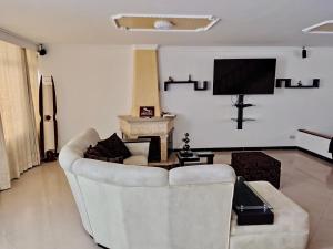 a living room with a couch and a tv at Casa cerca al Campín in Bogotá