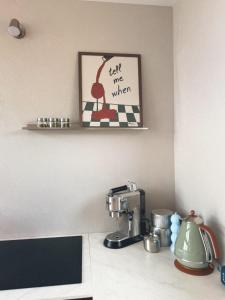 a kitchen counter with a mixer and a picture on the wall at Ostoja Janowice in Janowice