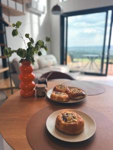 two donuts on plates on a wooden table at Ostoja Janowice in Janowice