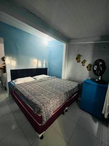 a bedroom with a bed and a blue wall at Blue Day in Canoa Quebrada +13 photos