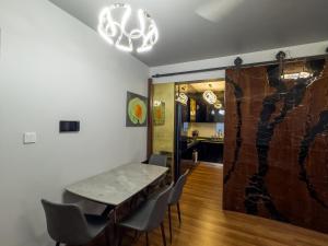a dining room with a table and chairs at Araam Retreat Deluxe in Male City +5 photos
