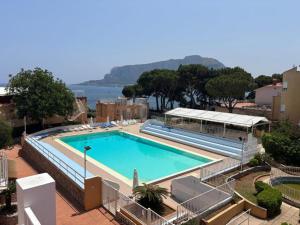 a large swimming pool next to the water at Ashur mondello in Palermo
