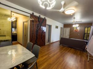a living room with a table and a couch at Araam Retreat Deluxe in Male City