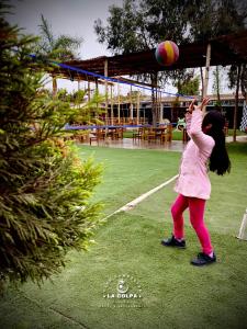 two young girls playing with a volley ball at Hacienda Hotel Colpa in Chincha