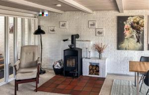 a living room with a brick wall with a fireplace at Awesome Home In Thyborøn With Wifi in Thyborøn