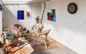 a room with chairs and a table and a wall at Awesome Home In Thyborøn With Wifi in Thyborøn +16 photos