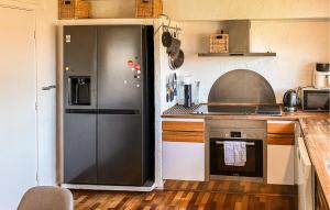 a kitchen with a refrigerator next to a stove at Awesome Home In Thyborøn With Wifi in Thyborøn