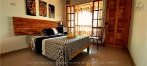 a bedroom with a bed and a table and a window at Hacienda Hotel Colpa in Chincha