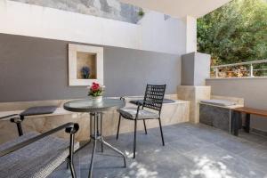 a patio with a table and a chair at Villa Petra in Neum