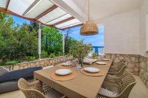 a dining room with a table and chairs at Villa Empress in Dramalj