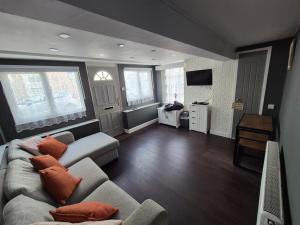 a living room with a couch and a tv at Ground floor 1 bed flat in Weymouth