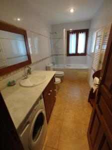 a bathroom with a sink and a washing machine at Casa Cosculluela in Aínsa +78 photos