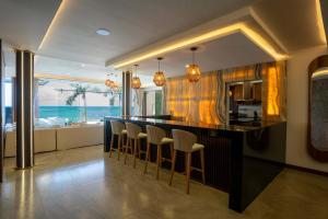 a kitchen with a bar with a view of the ocean at Villa Magdalena - 7BR - Oceanfront with Heated Pool in Cancún
