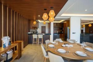 a dining room with a large wooden table and chairs at Villa Magdalena - 7BR - Oceanfront with Heated Pool in Cancún +63 photos