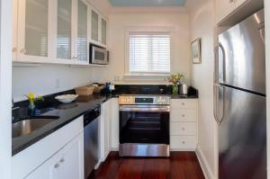 a kitchen with a stove and a sink at Breakwater Inn in Kennebunkport
