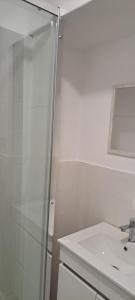 a white bathroom with a shower and a sink at Elvasguesthouse in Elvas