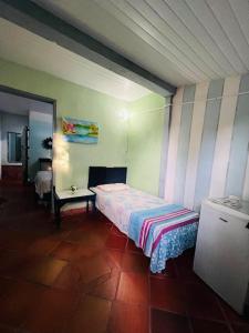 a bedroom with a bed and a table in it at Blue Day in Canoa Quebrada
