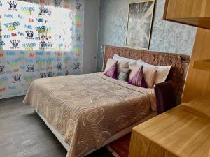 a bedroom with a large bed with purple pillows at Sudresidence in Agadir +79 photos