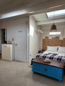 a bedroom with a bed with a blue wooden table at The three bell towers apartment in Alghero