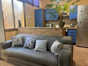 a couch with pillows on it in a kitchen at Galliu'S home in Selargius