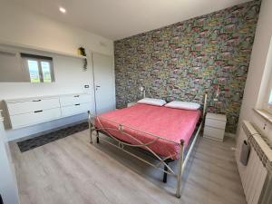 a bedroom with a bed with a red blanket at VILLA NATURA in Corropoli +8 photos