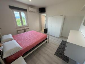 a bedroom with a large bed with a red blanket at VILLA NATURA in Corropoli