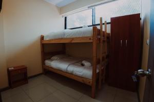 two bunk beds in a room with a window at HoTELBLU in Santiago